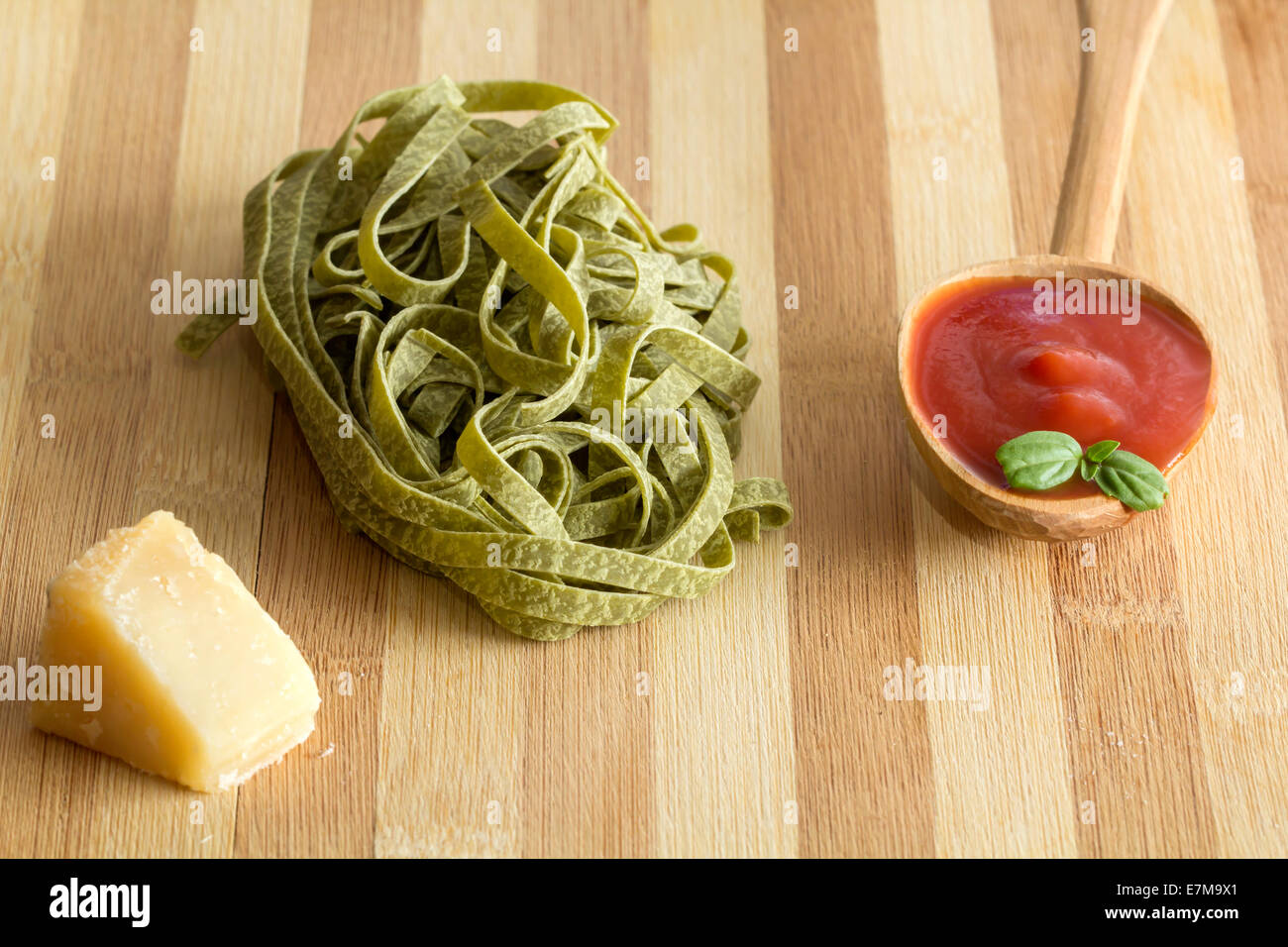 Pasta ingredients; fresh tagliatelle, tomato, parmigiano. Selective focus Stock Photo