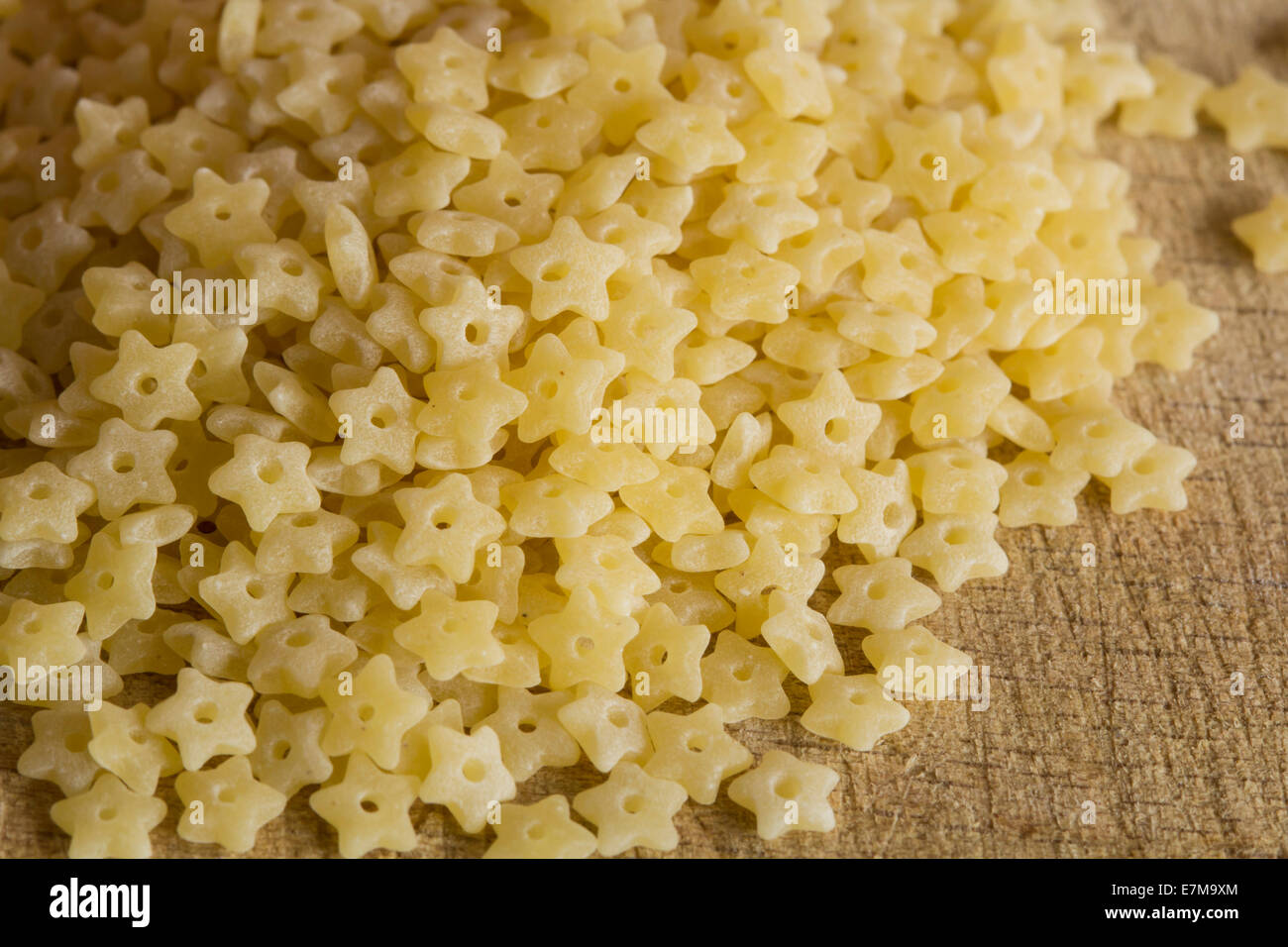 Closeup made of raw stars macaroni on wood background Stock Photo