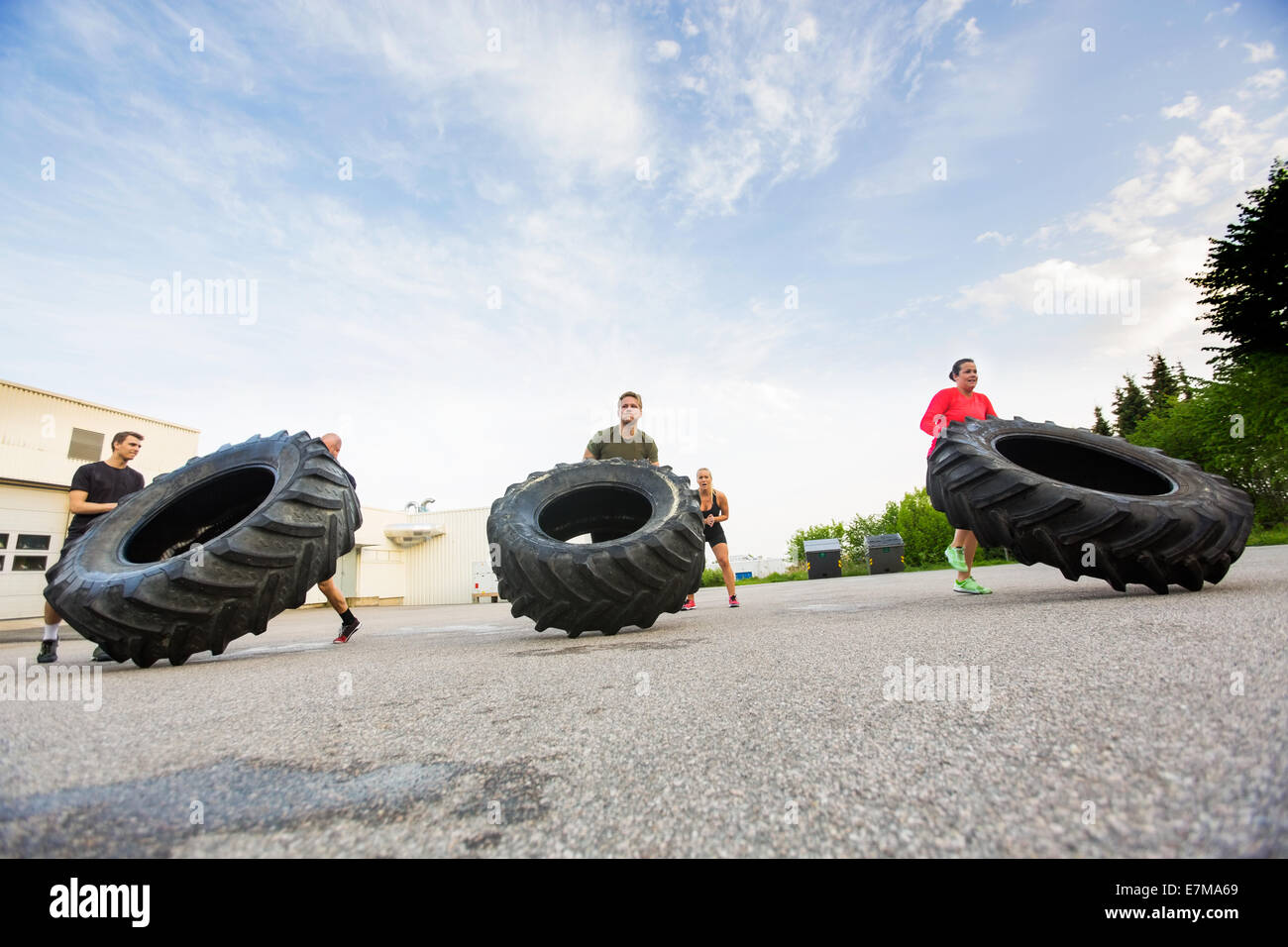 Athletes Doing TireFlip Exercise Stock Photo Alamy