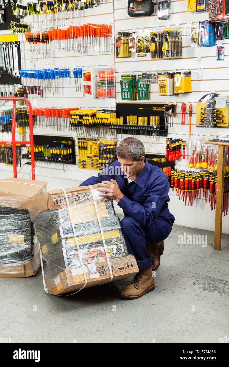 Worker Lifting Tool Package In Hardware Shop Stock Photo Alamy