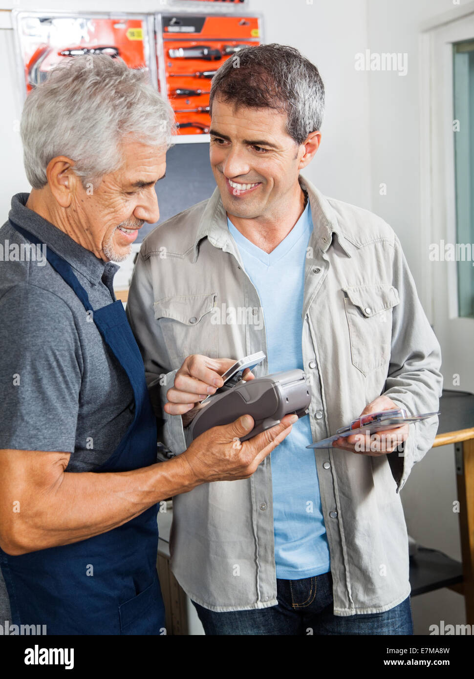 Customer Paying Through Smartphone In Hardware Store Stock Photo Alamy