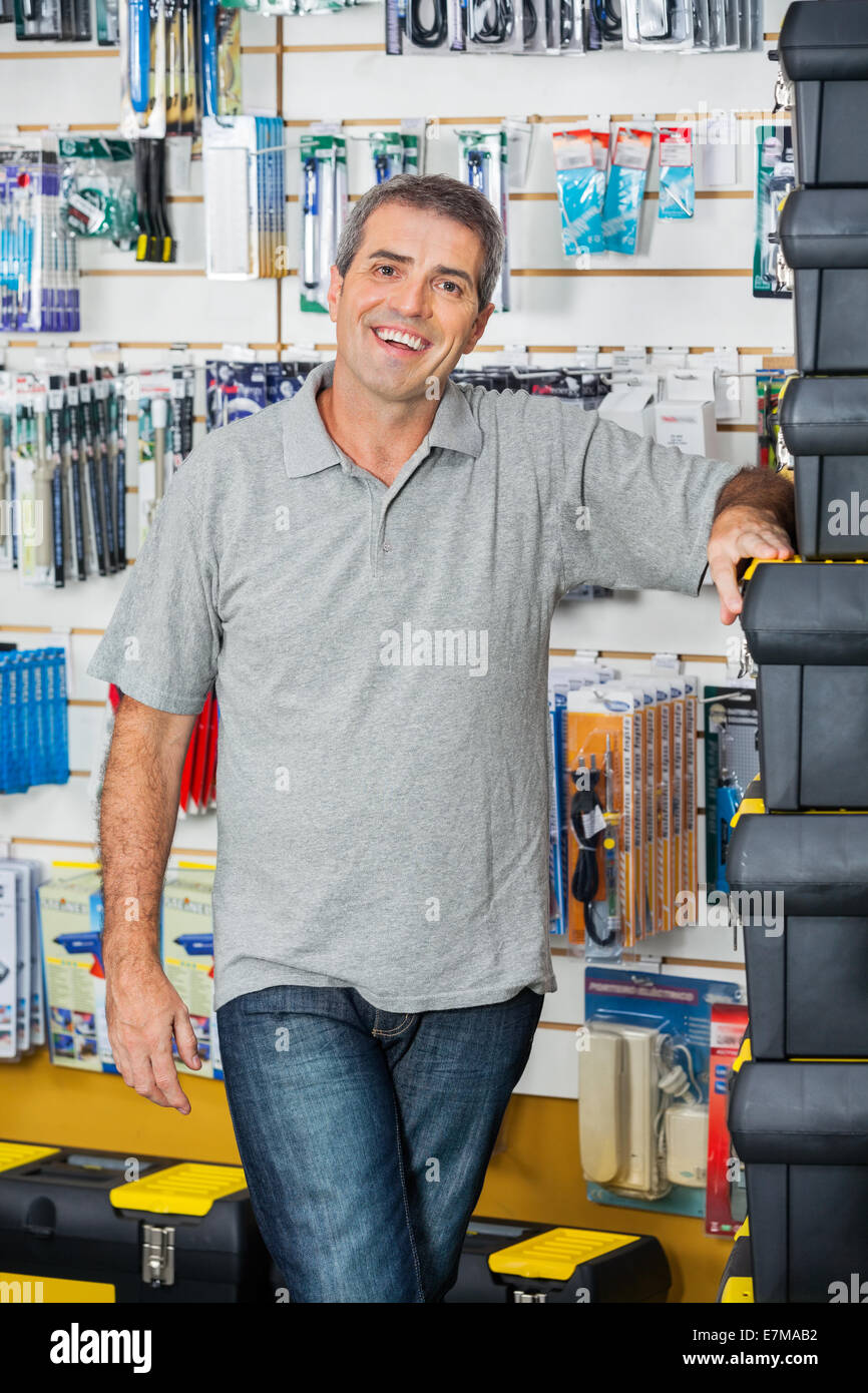 Man Standing By Stacked Toolboxes In Store Stock Photo