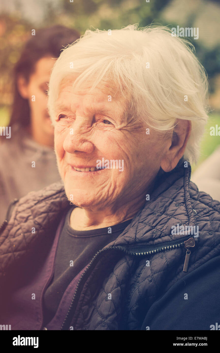 Portrait of a grandmother daydreaming, face only, closeup. Retro colors Stock Photo
