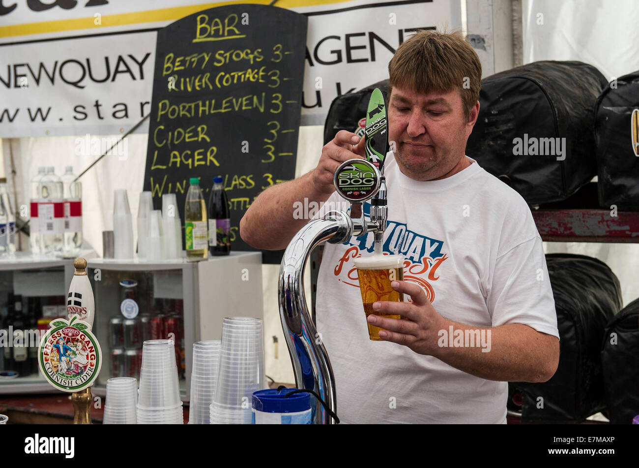 Barstaff pouring a pint of beer at the Newquay Fish Festival in Newquay Harbour. Stock Photo