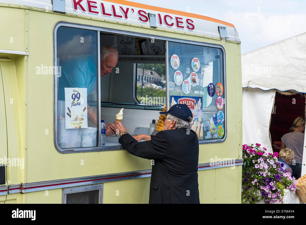 An elderly man buying an ice cream from an ice cream van. Stock Photo