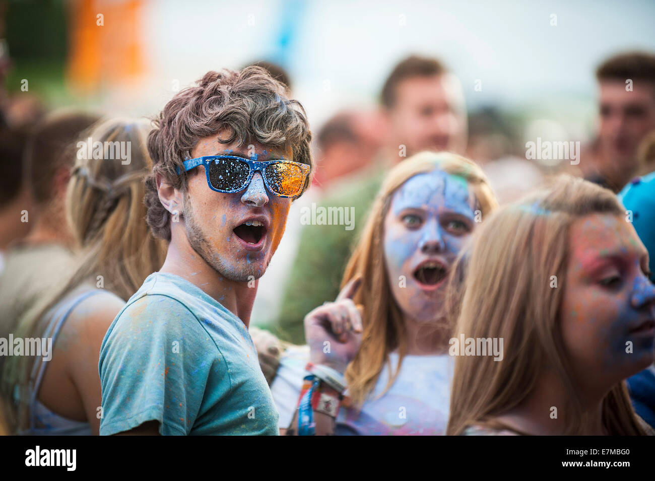 Festivalgoers covered in coloured powder at the Brownstock Festival in Essex. Stock Photo