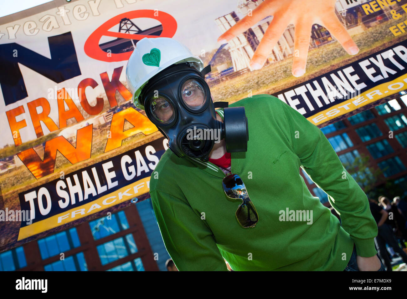 Sinister figure wearing gas mask, placards and banners at Frack Free Greater Manchester’s rally and lobby of the Labour Party Conference in Manchester. A march from Piccadilly Gardens to demand action on Climate Change.  Frack Free Greater Manchester expects the rally to be the largest gathering against fracking in the UK. Stock Photo