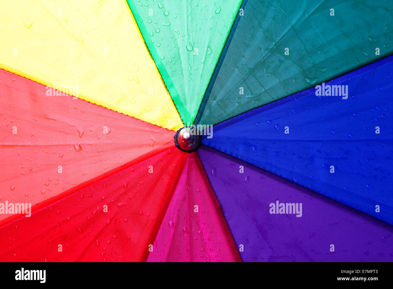 Closeup of a colorful umbrella with rain drops Stock Photo