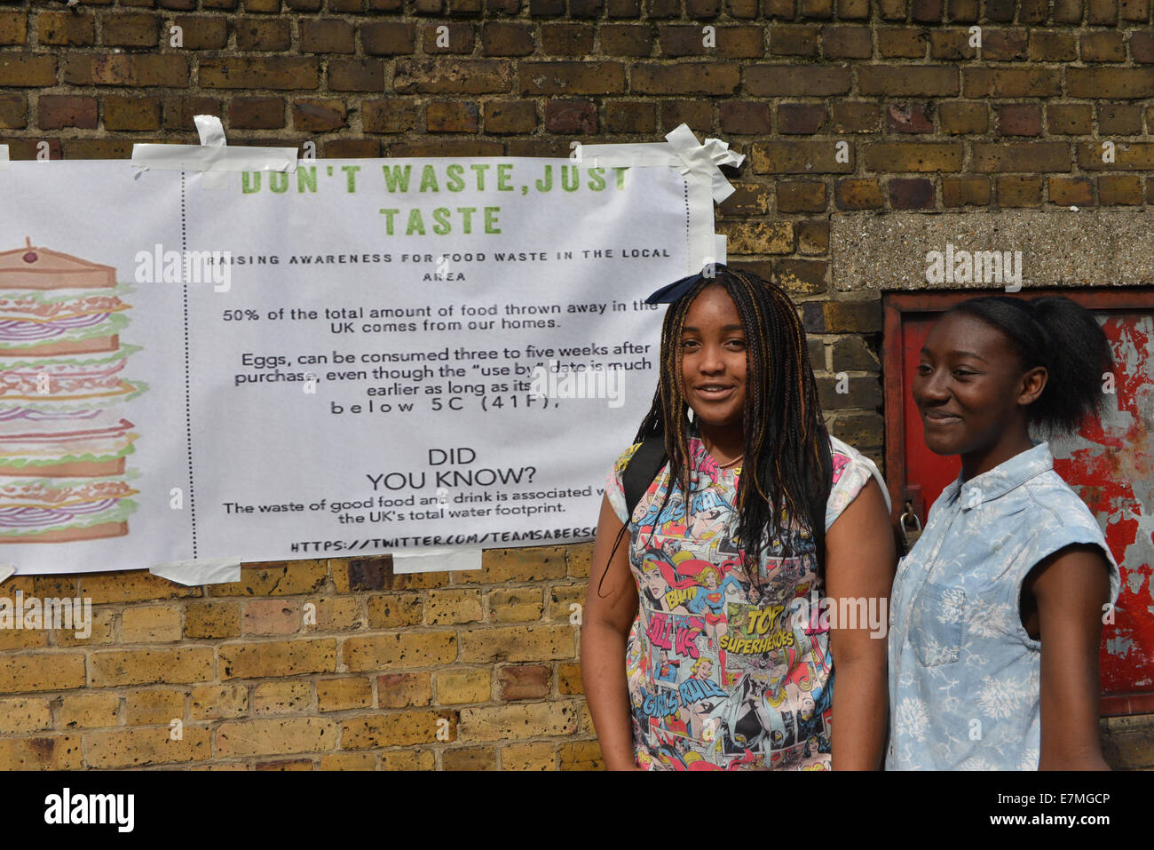 Victoria Embankment, London, UK. 21st September 2014. Two girls with a don't waste food banner. The People's Climate  March moves along Victoria Embankment. Credit:  Matthew Chattle/Alamy Live News Stock Photo