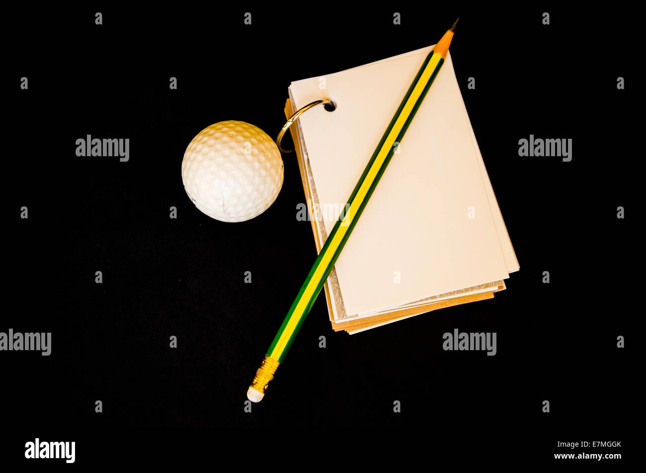 golf ball with notebook score card on black background Stock Photo