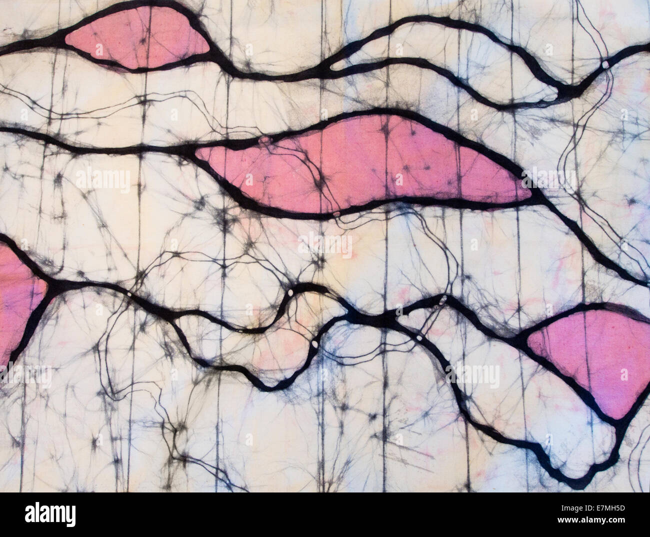 Partial close up of colourful wax batik artwork, abstract lines and irregular patches in black, pink and white Stock Photo