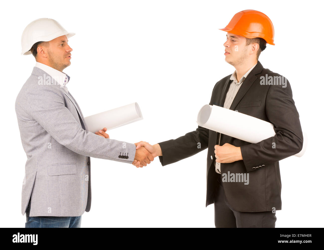 Middle Age Engineers in Gray and Black Attire Shaking Hands and Holding Blueprints. Isolated on White Background. Stock Photo