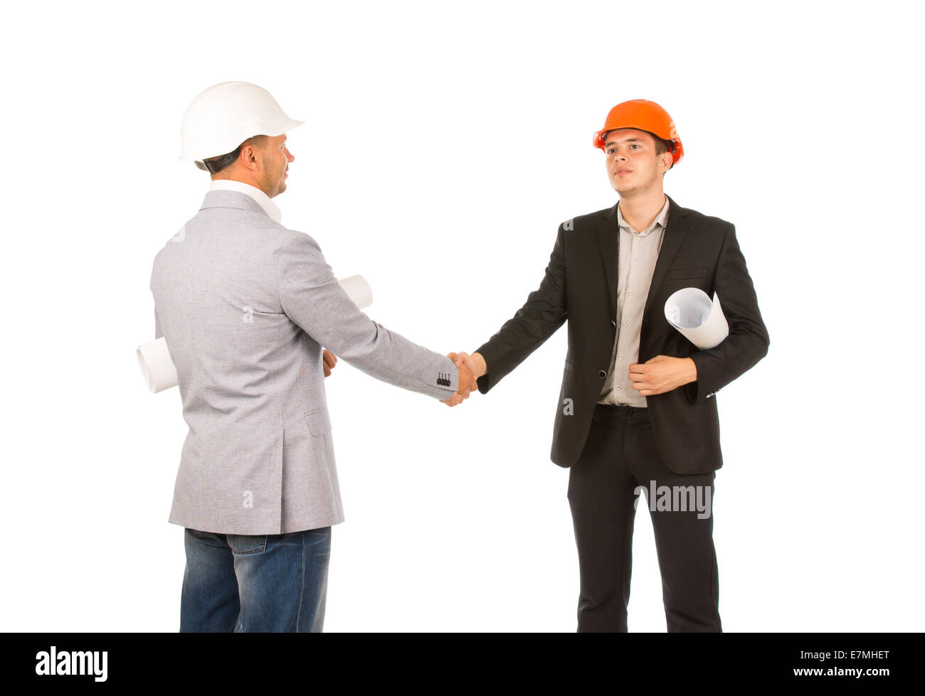 Two Caucasian Middle Age Engineers Shaking Hands with Blueprints. Isolated on White Background. Stock Photo