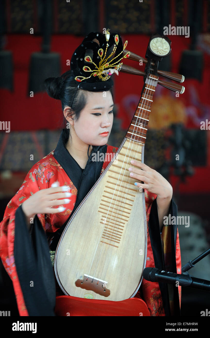 Performer plays the Chinese Lute for tourists in the Summer Palace in Beijing, China. 2014 Stock Photo