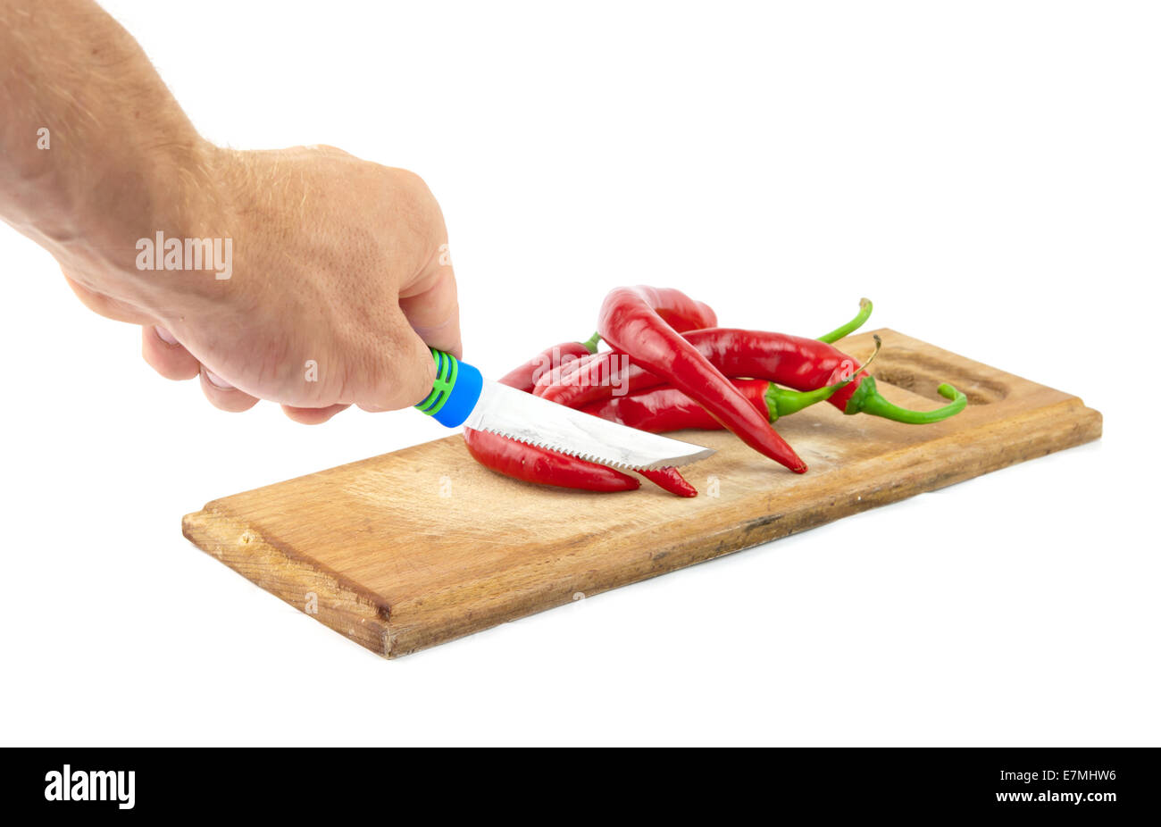 red pepper, steel knife and wooden board, all isolated on white Stock Photo