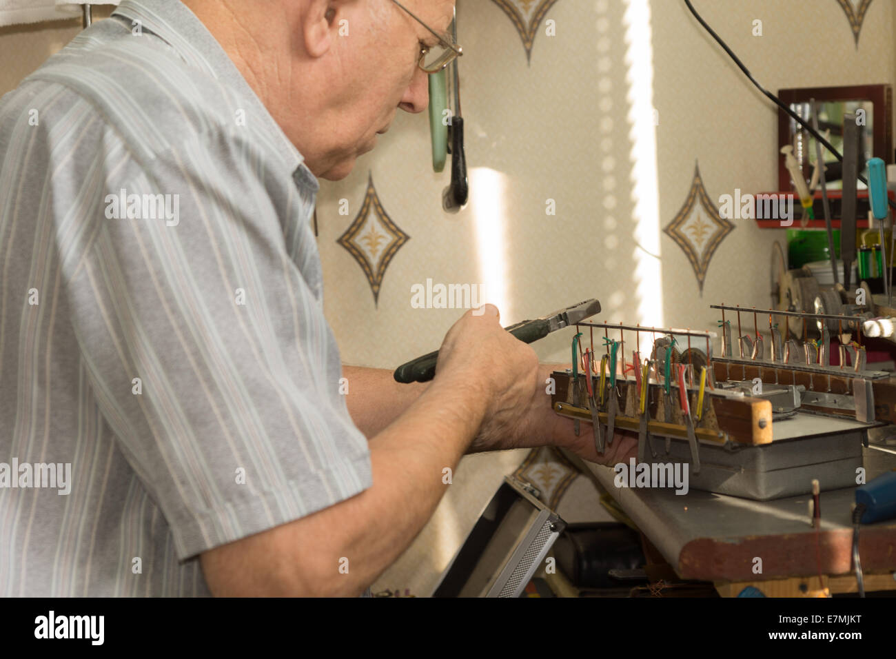 Close up Old Man Working Electronic Device Project Using Pliers on ...