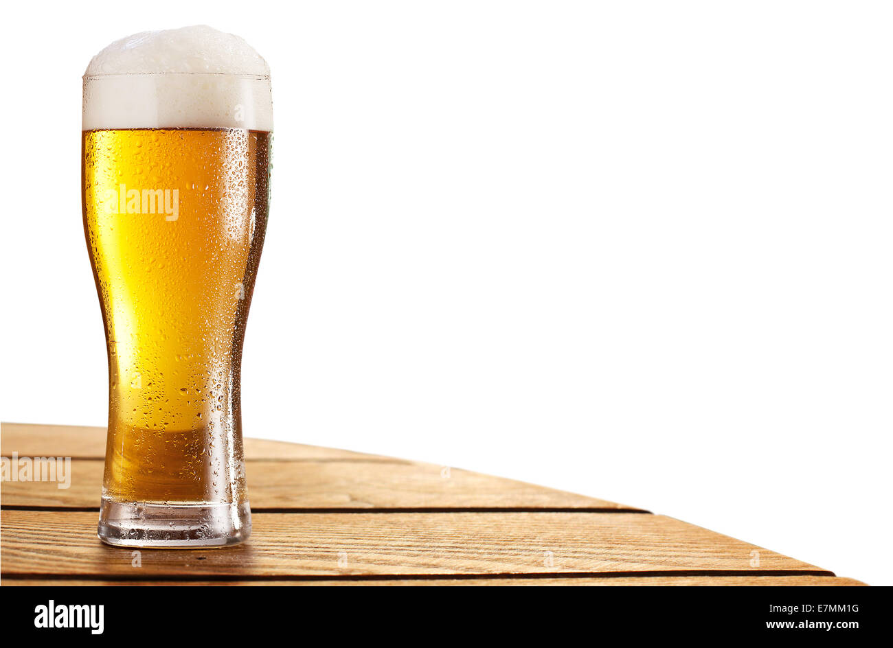 Beer glass on the bar table isolated on a white. Contains clipping paths. Stock Photo