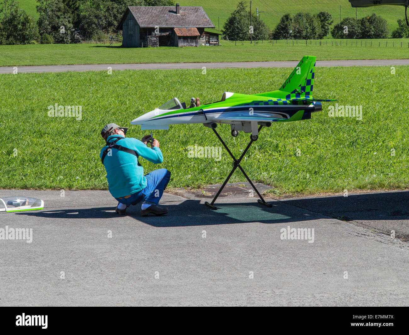 Model aircraft enthusiast repairing the nose wheel of his jet aircraft which was damaged on landing Stock Photo