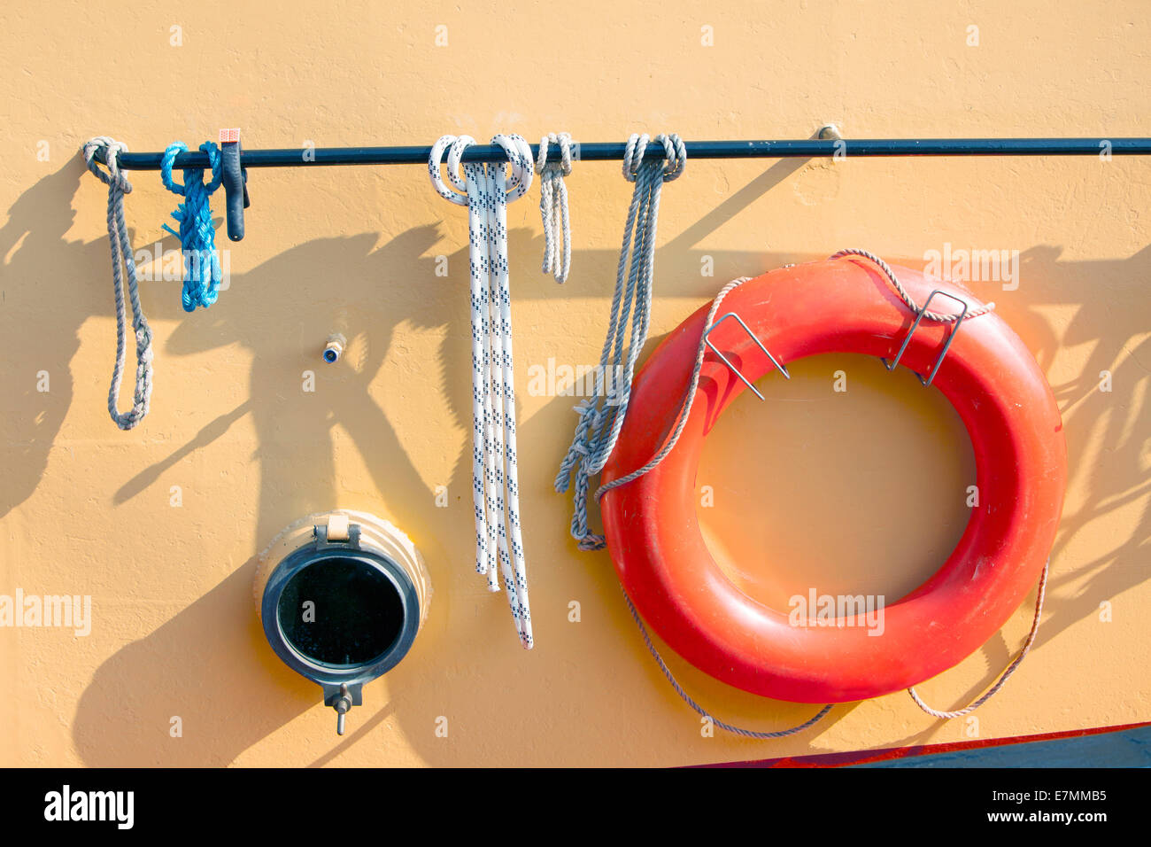 orange lifebuoy on metal ship with small porthole Stock Photo Alamy