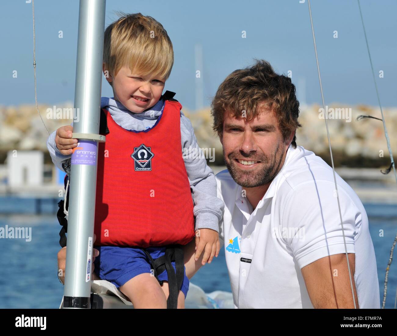 Portland, UK. 21st Sep, 2014. Bart's Bash at the National Sailing Academy at Portland in Dorset. Andrew Simpson's Olympic sailing buddy Iain Percy with Andrew's son Freddie as they are about to leave to take part in the largest yacht race in the world today (Sunday 21st Sept) sailing in his 'Star Class' yacht that they won a silver medal in at London 2012. The event is a huge charity one in response to Andrew's sudden death whilst sailing in an America's cup yacht. 21st September, 2014 Picture:  Credit:  Dorset Media Service/Alamy Live News Stock Photo