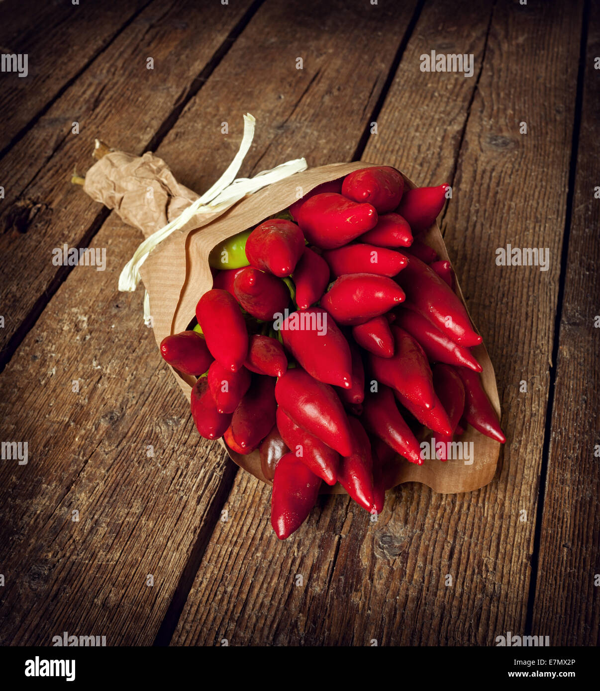 Bunch of fresh small red hot pepper  on wooden table Stock Photo