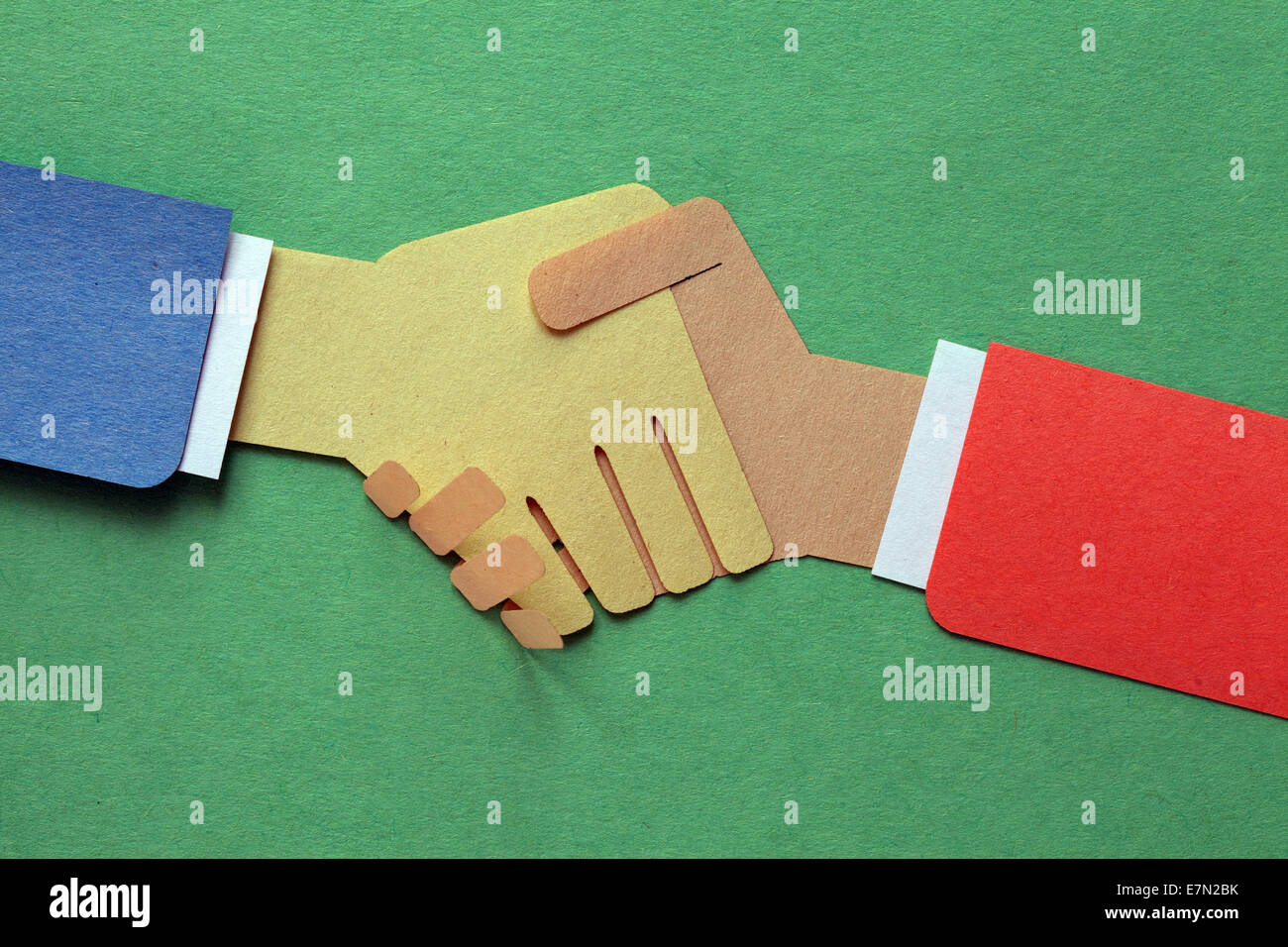 Handshake, businessmen making a deal - cut paper Stock Photo