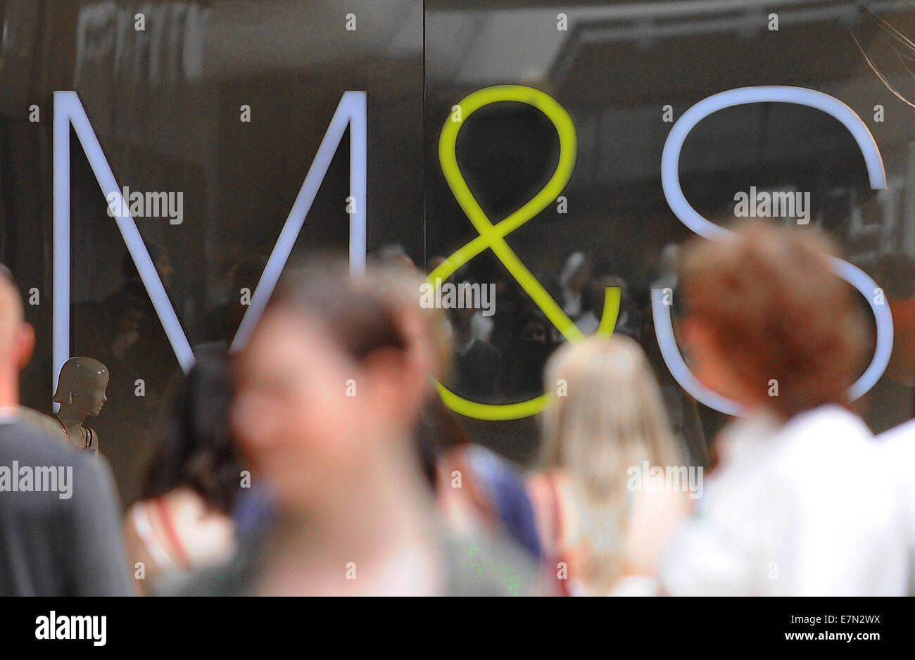 Shoppers in front of a Marks and Spencer (M&S) retail store on the high street. Stock Photo