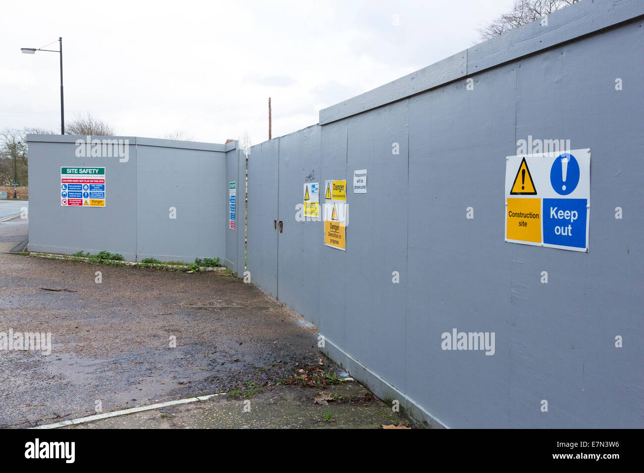 boarding with safety warning signs outside a construction site in the UK Stock Photo