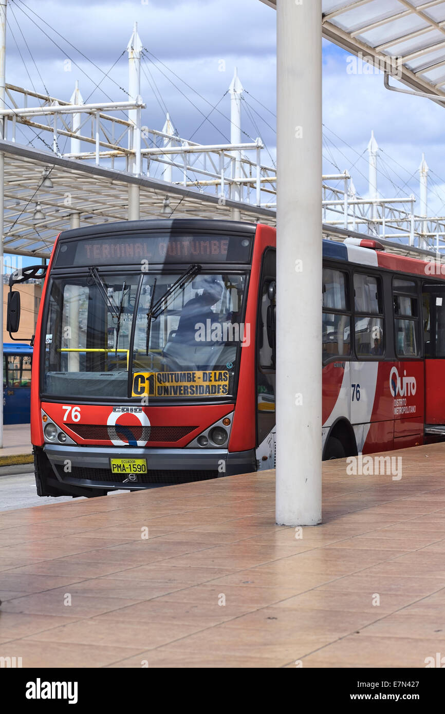Bus of C1 line of the local public transport system Metrobus-Q standing at platform outside Quitumbe Terminal in Quito, Ecuador Stock Photo
