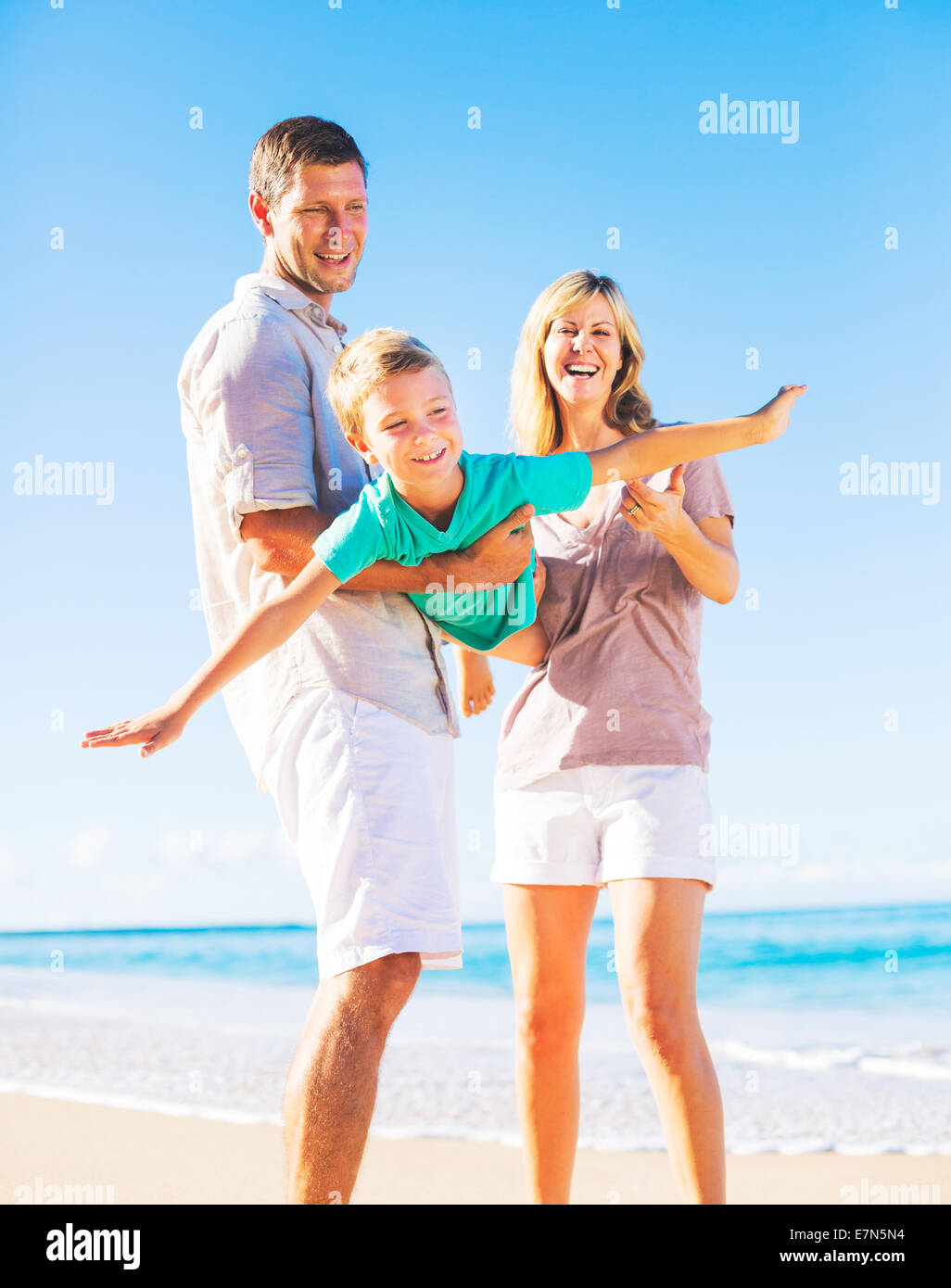 Family on beach playing together hi-res stock photography and images ...