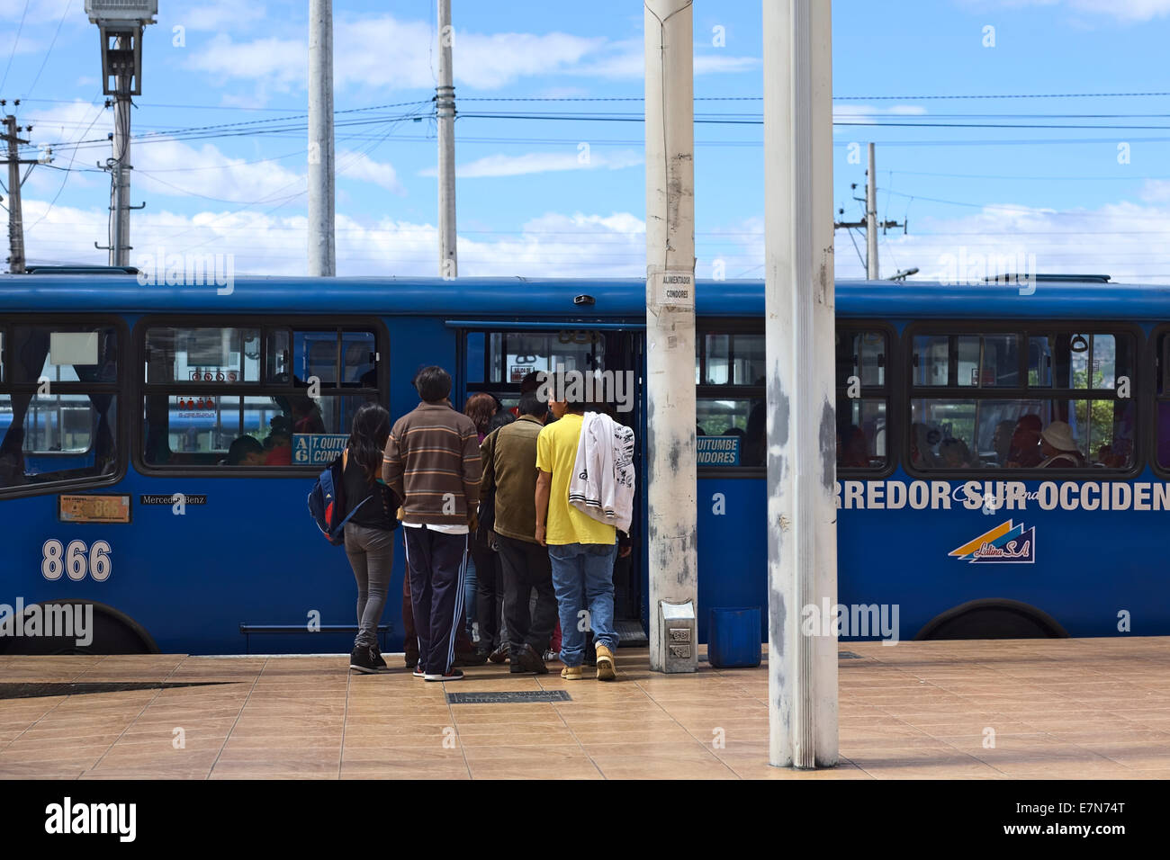 Unidentified people getting into a bus of the line A6 (Quitumbe - Los Condores) outside the Quitumbe Terminal in Quito, Ecuador Stock Photo