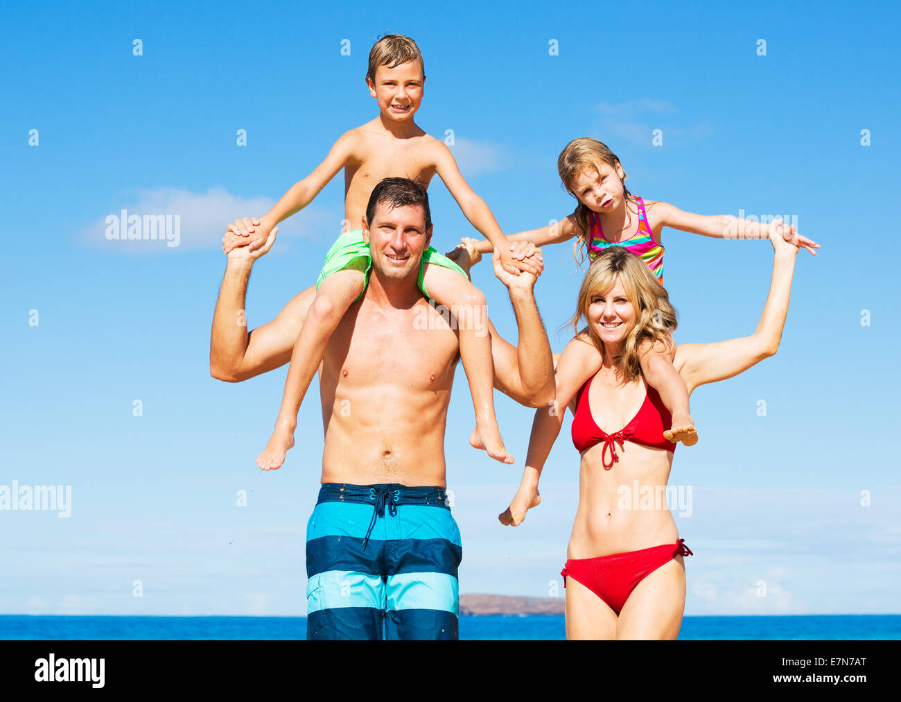 Happy Family Having Fun on the Beach Stock Photo