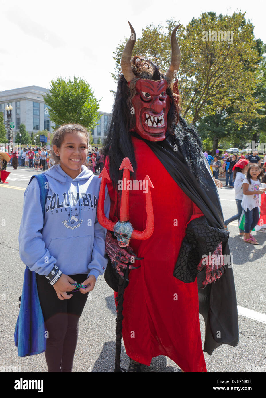 Woman posing for pictures with El diablo (The devil) character at Latin festival - Washington, DC USA Stock Photo