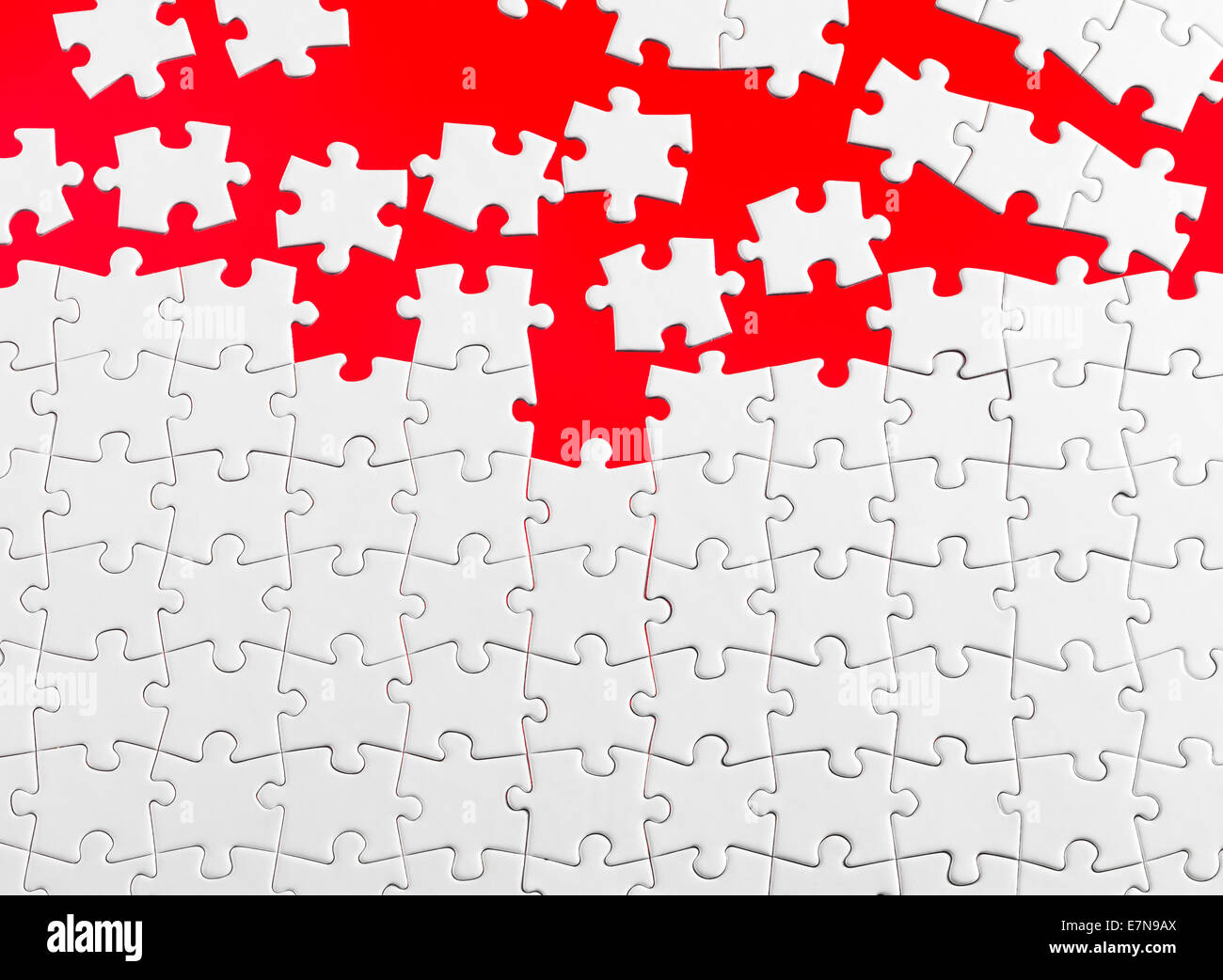 Jigsaw pieces with a red background Stock Photo