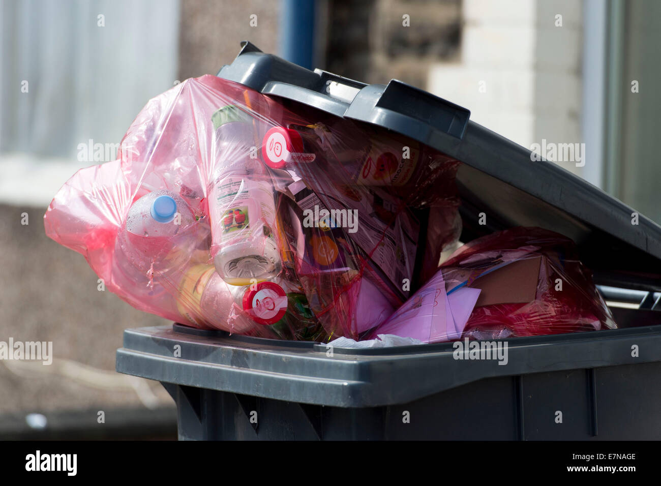 An overloaded green recycling bin full of rubbish in Cardiff, South