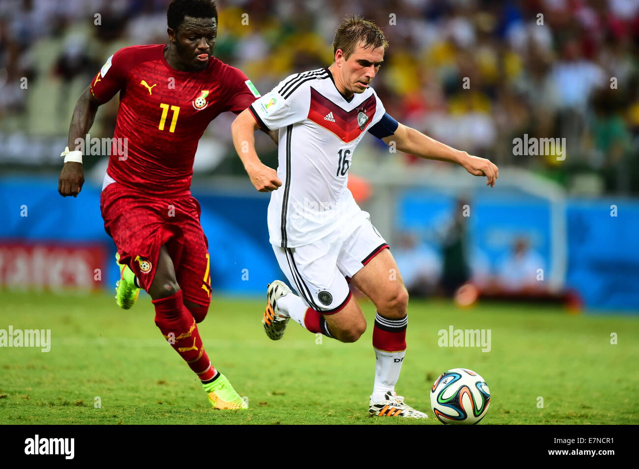 Philipp Lahm of Germany and Sulley Muntari of Ghana.  Germany v Ghana, group match. FIFA World Cup 2014 Brazil. Castelao Stadium Stock Photo