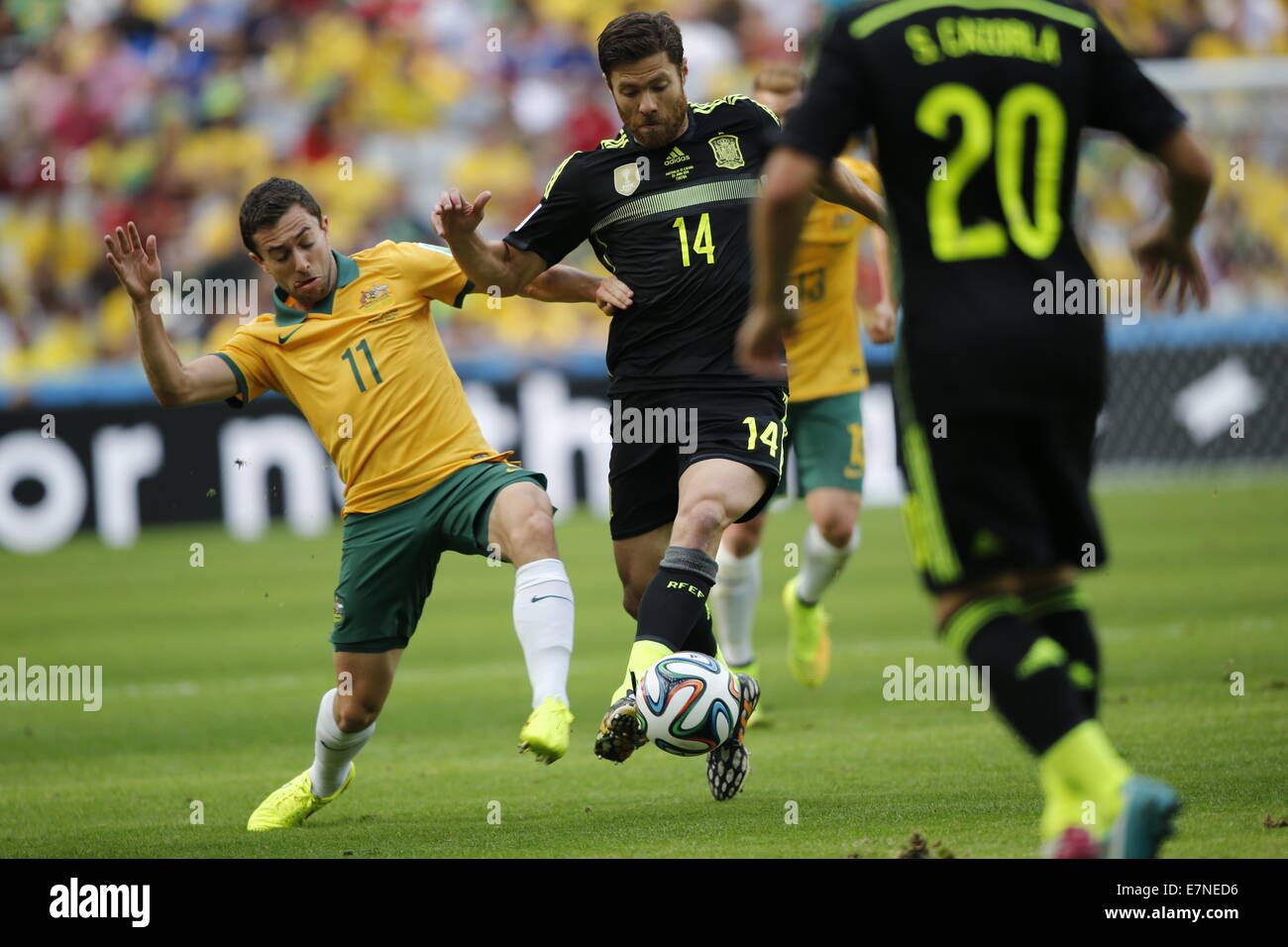 Tommy Oar and Xabi Alonso. Australia v Spain, group match. FIFA World Cup Brazil 2014. Arena da Baixada, Curitiba. 23 June 2014 Stock Photo