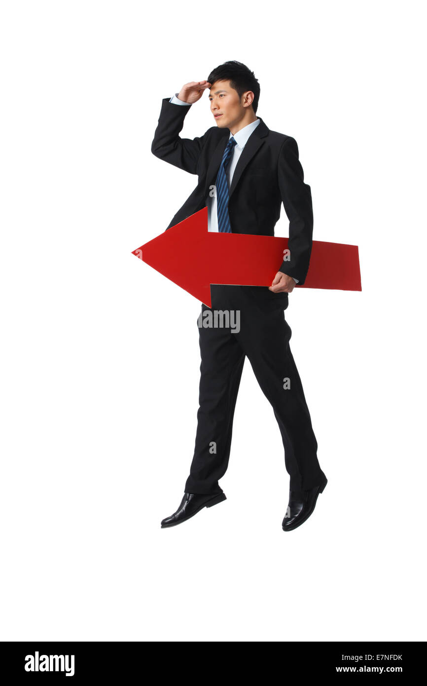 Business man holding a red arrow Stock Photo - Alamy