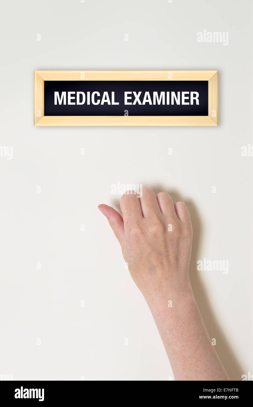 Female hand is knocking on medical examiner door for a medical exam Stock Photo