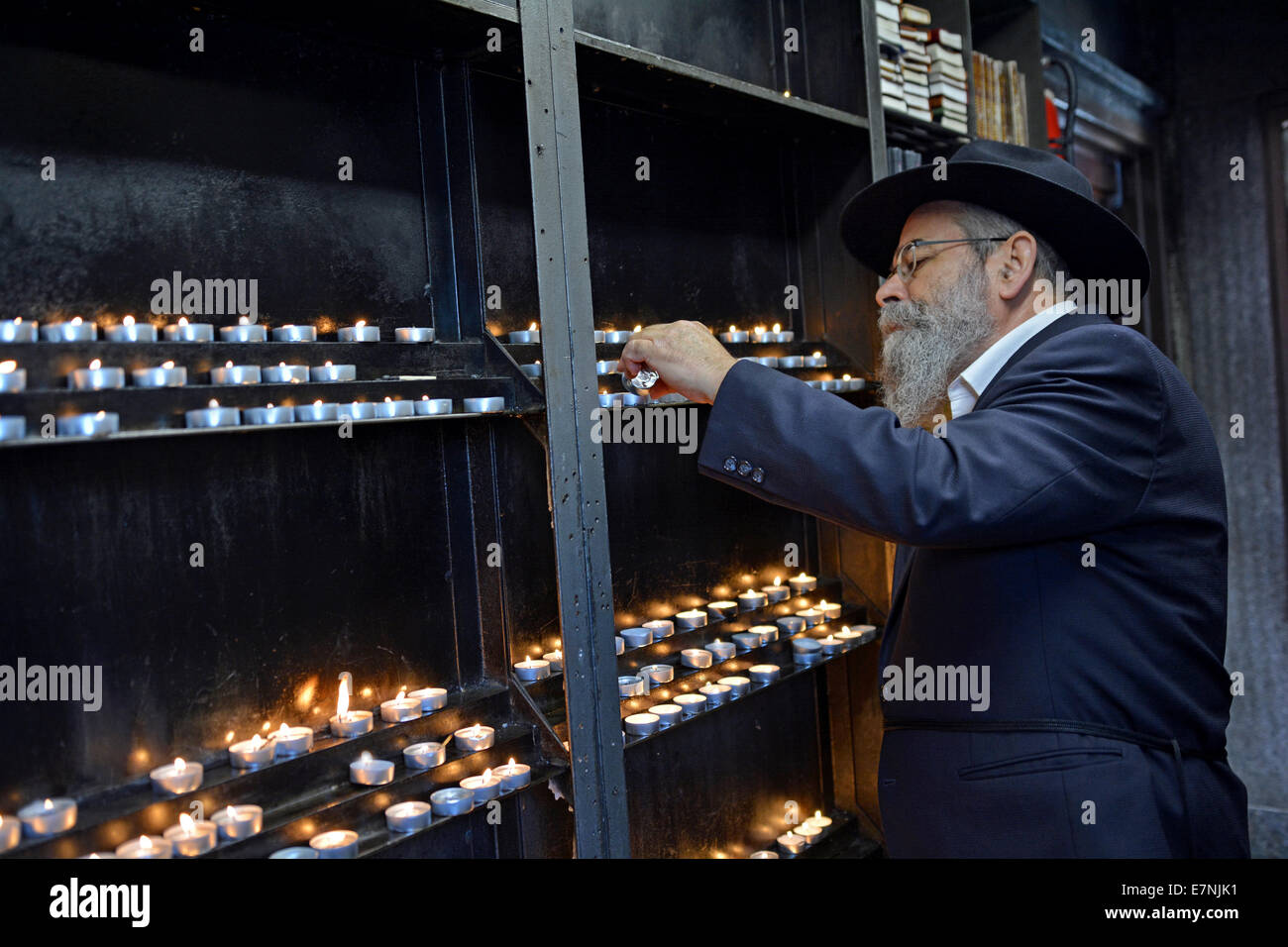 Religious Jewish man lights a candle prior to visiting the grave of the Lubavitcher Rebbe in Cambria Heights, Queens, New York Stock Photo