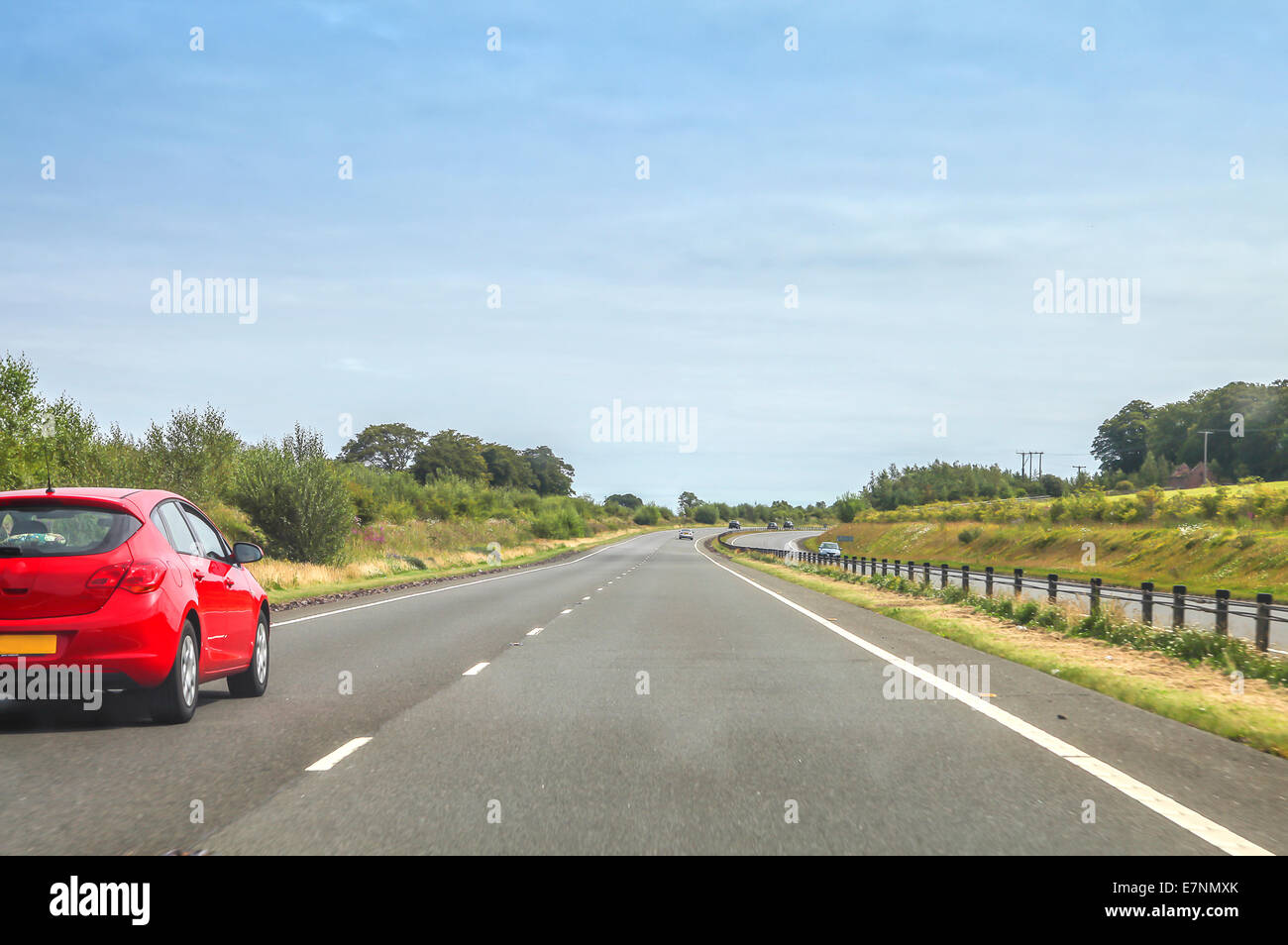 Red car driving on the left side Stock Photo