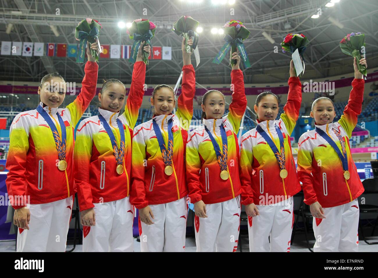 Incheon, South Korea. 22nd Sep, 2014. Chinese athletes Huang Huidan, Yao Jinnan, Bai Yawen, Tan Jiaxin, Chen Siyi and Shang Chunsong (from L to R) pose on the podium during the awarding ceremonoy of women's team contest of gymnastics artistic event at the 17th Asian Games in Incheon, South Korea, Sept. 22, 2014. China won the gold medal with 229.300 points. Credit:  Zheng Huansong/Xinhua/Alamy Live News Stock Photo