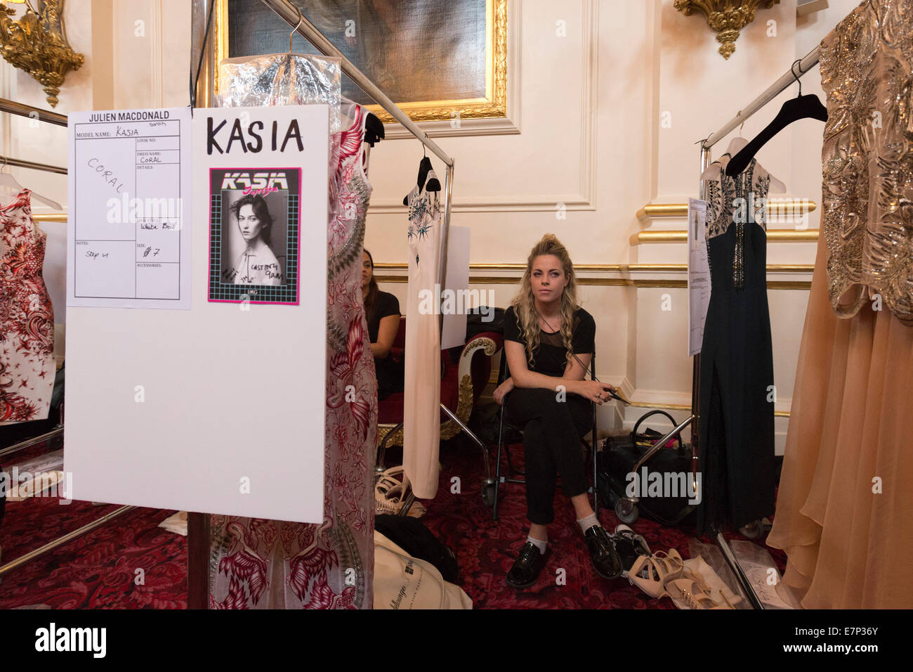 A dresser waits for a model. Backstage before the Julien Macdonald London Fashion  Week catwalk show at the Royal Opera House Stock Photo - Alamy