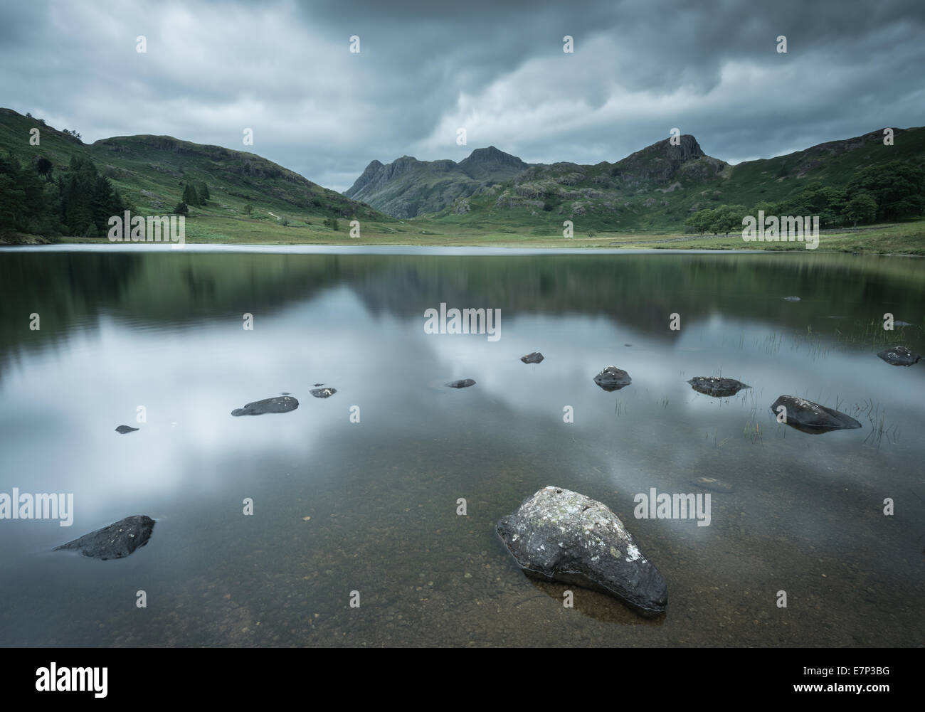 Gathering storm clouds over Blea Tarn and the Langdale Pikes, English Lake District Stock Photo