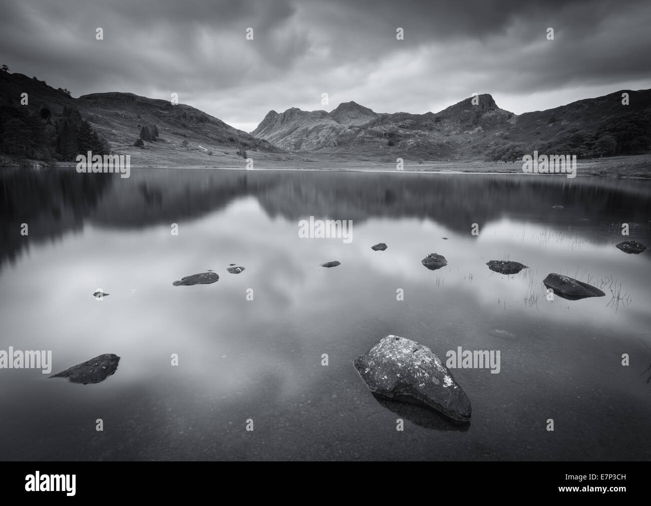 Black and white stormy Blea Tarn and Langdale Pikes, English Lake District Stock Photo