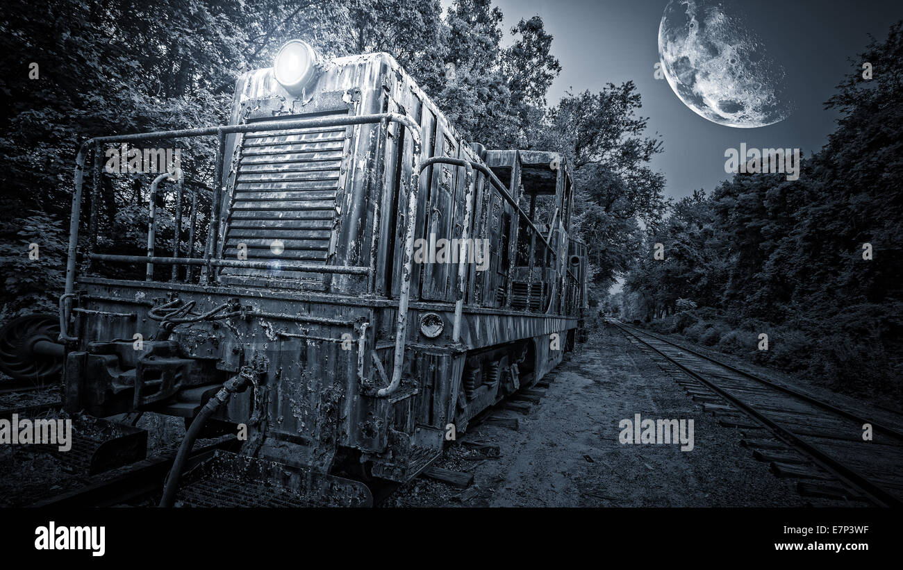 A ghost train barreling down the tracks at night under the moonlight. Stock Photo