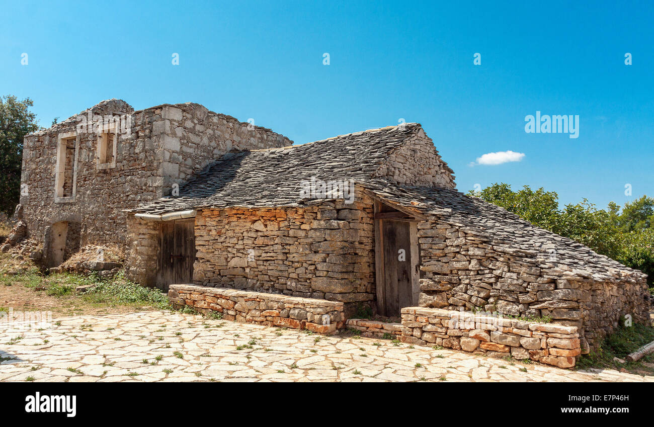 Stone farm buildings in deserted Humac village, Hvar island, Croatia ...