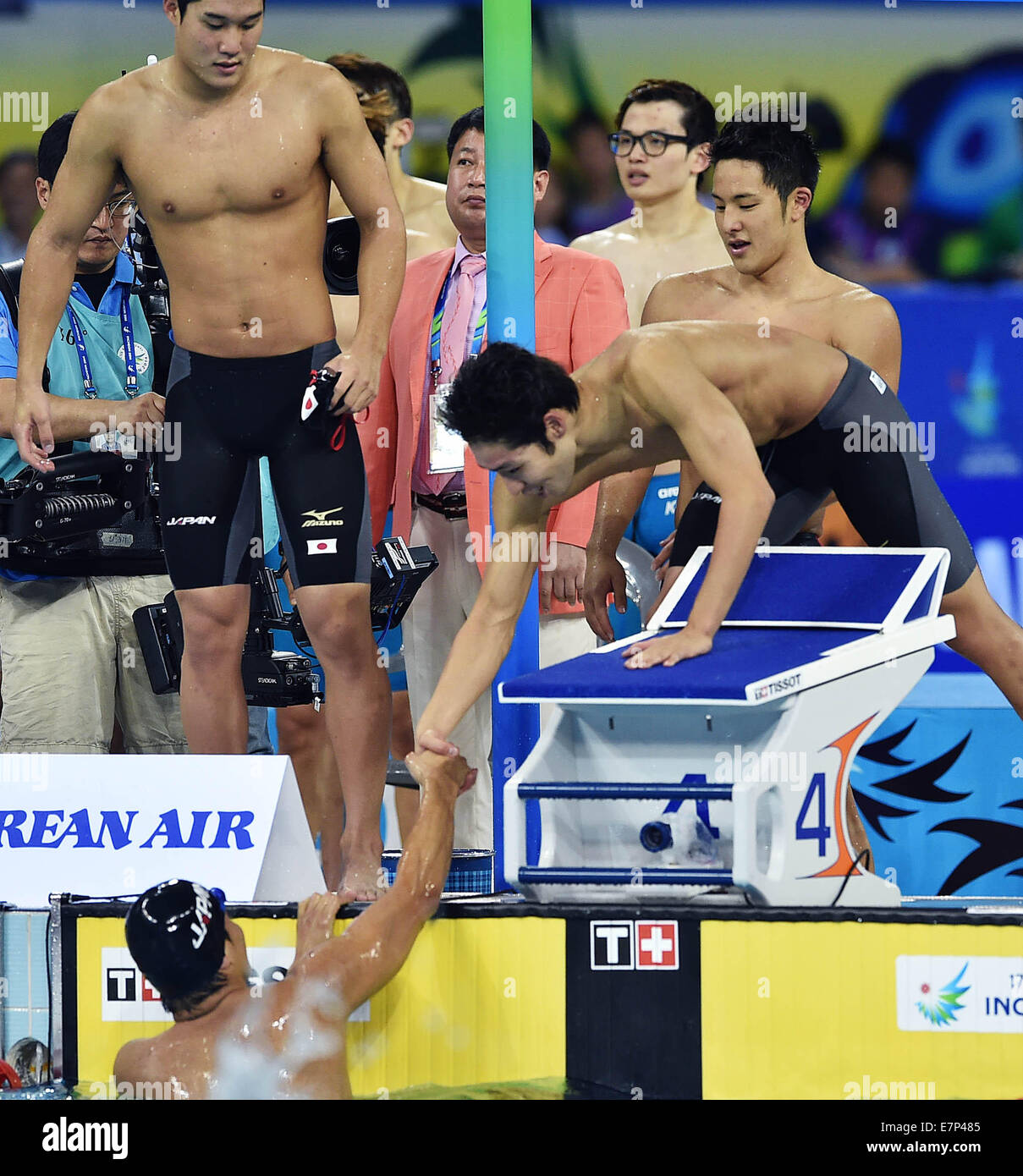 Incheon, South Korea. 22nd Sep, 2014. Japanese swimmers celebrate after the men's 4×200m freestyle relay final of swimming event at the 17th Asian Games in Incheon, South Korea, Sept. 22, 2014. Japan won the gold medal with 7 minutes and 06.74 seconds. Credit:  Wang Peng/Xinhua/Alamy Live News Stock Photo