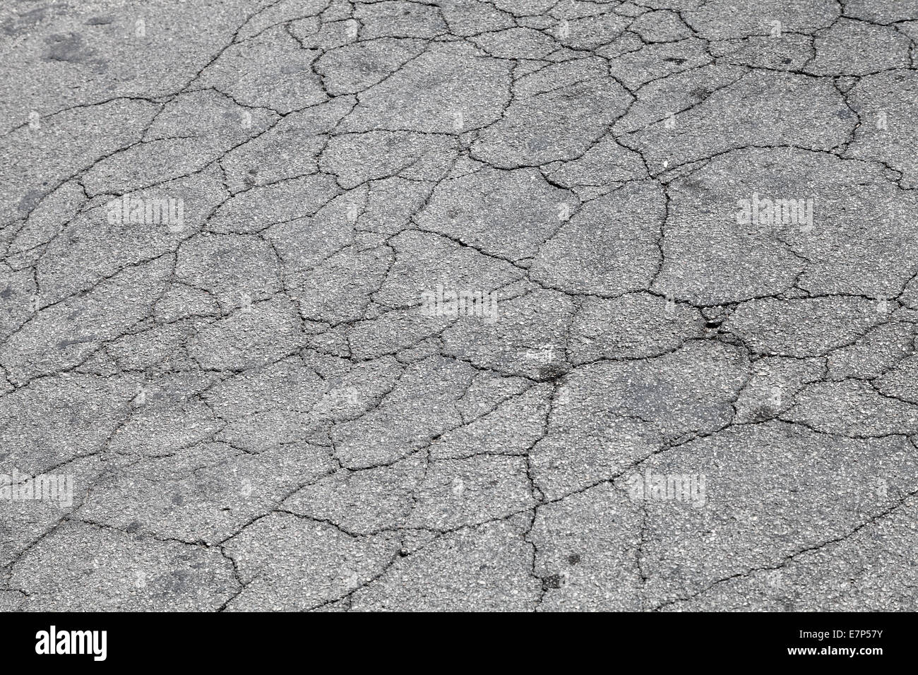 Grungy asphalt with cracks, urban background texture Stock Photo