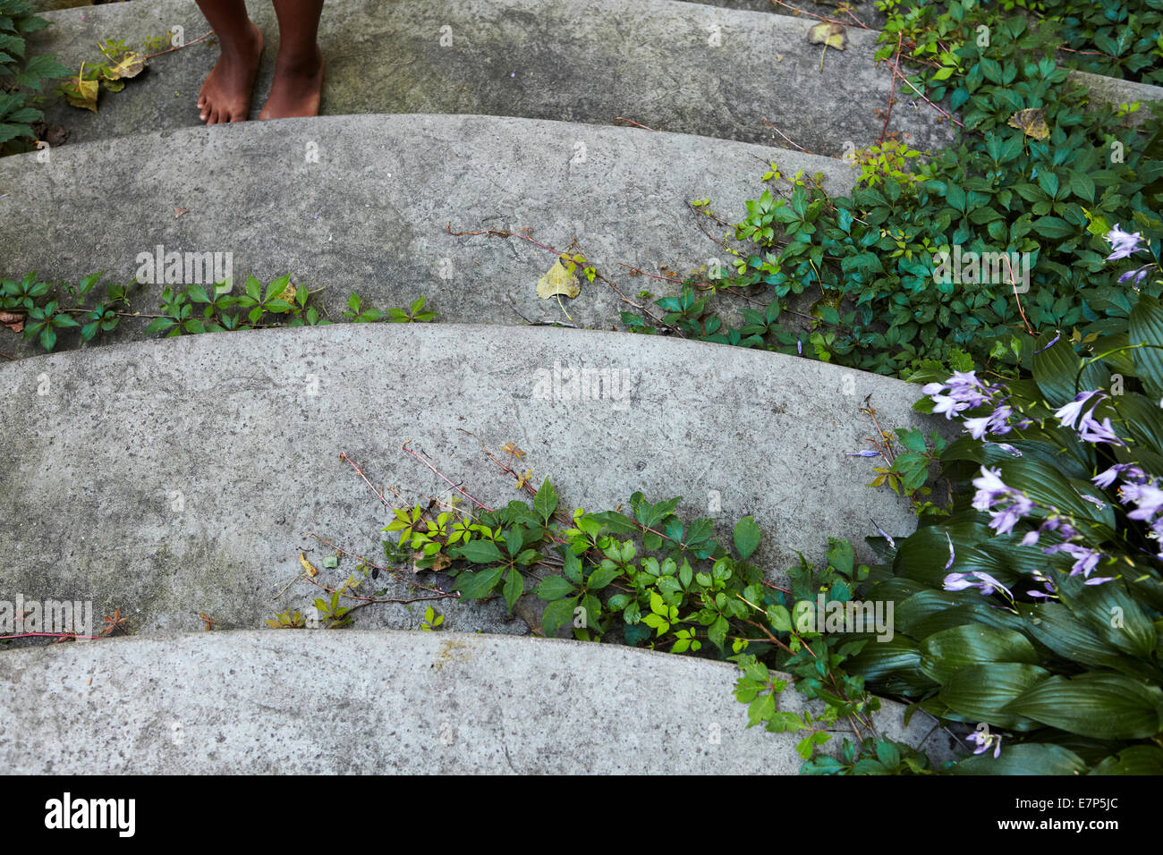 Bare feet of black child at bottom of steps Stock Photo